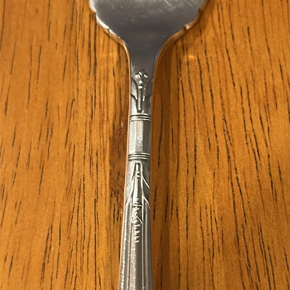 Oneida Tudor plate silver salad fork. Neck is rounded and has a slit edge.